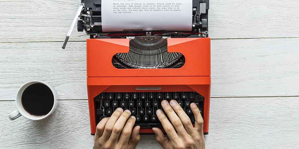 Aerial view of a man typing on a retro typewriter